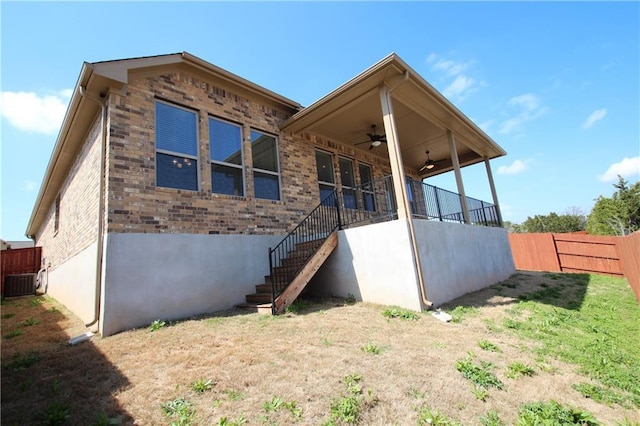 2204 Cabrillo Path, Leander, TX 78641 - rear view of house featuring a ceiling fan, stairway, brick siding, and central AC