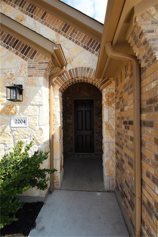 2204 Cabrillo Path, Leander, TX 78641 - doorway to property featuring stone siding and brick siding