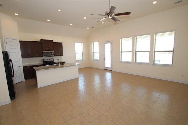 2204 Cabrillo Path, Leander, TX 78641 - kitchen featuring stainless steel microwave, lofted ceiling, open floor plan, stove, and recessed lighting