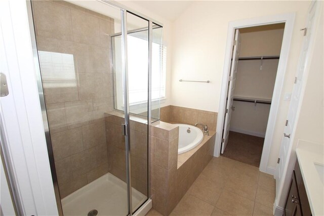 2204 Cabrillo Path, Leander, TX 78641 - bathroom with a garden tub, vanity, a shower stall, a walk in closet, and tile patterned floors