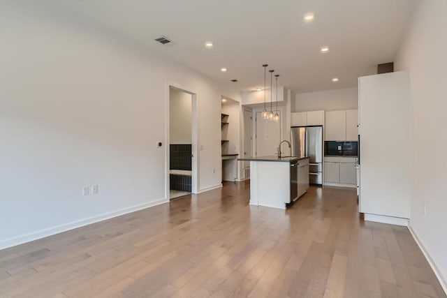 207 W Johanna Unit 108, Austin, TX 78704 - unfurnished living room with wood finished floors and recessed lighting