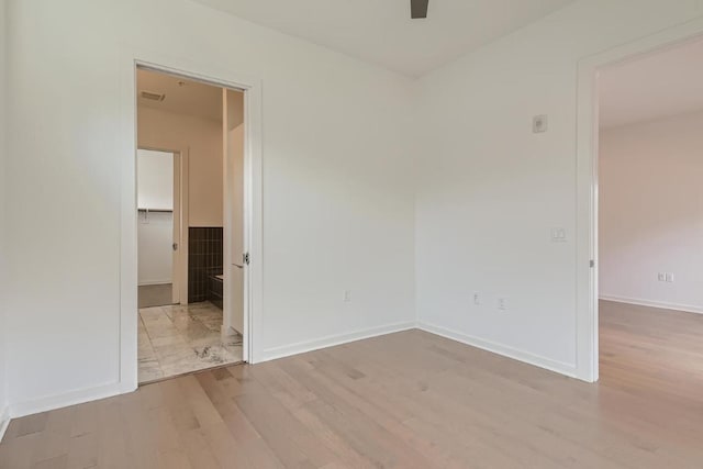 207 W Johanna Unit 108, Austin, TX 78704 - spare room with wood finished floors, ceiling fan, and baseboards