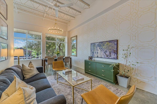 2401 E 6th St Unit 5077, Austin, TX 78702 - living area with baseboards, a chandelier, plenty of natural light, wallpapered walls, and a high ceiling
