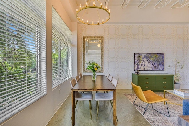 2401 E 6th St Unit 5077, Austin, TX 78702 - dining room featuring baseboards, a chandelier, healthy amount of natural light, and finished concrete floors