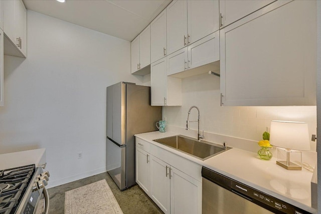 2401 E 6th St Unit 5077, Austin, TX 78702 - kitchen featuring a sink, appliances with stainless steel finishes, baseboards, and white cabinets