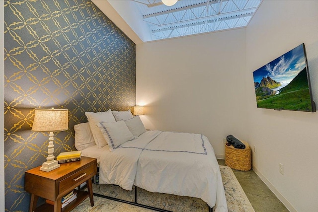 2401 E 6th St Unit 5077, Austin, TX 78702 - bedroom with wallpapered walls, baseboards, and a skylight