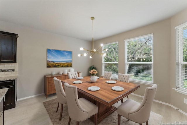 6739 Indian Lndg, San Antonio, TX 78253 - dining space with light wood-type flooring, healthy amount of natural light, a chandelier, and a fireplace