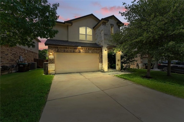 6739 Indian Lndg, San Antonio, TX 78253 - view of front of house featuring a lawn, a garage, concrete driveway, stone siding, and stucco siding