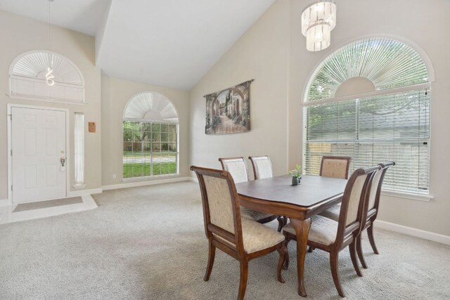 2917 Feathercrest Dr, Austin, TX 78728 - dining area featuring light colored carpet, a chandelier, and high vaulted ceiling