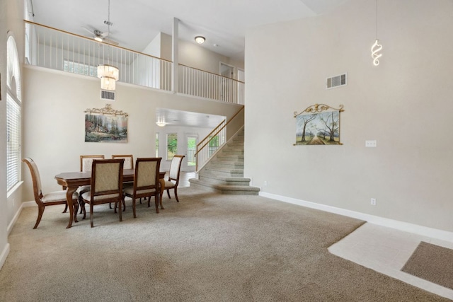 2917 Feathercrest Dr, Austin, TX 78728 - dining space featuring carpet floors, a high ceiling, a ceiling fan, and stairway