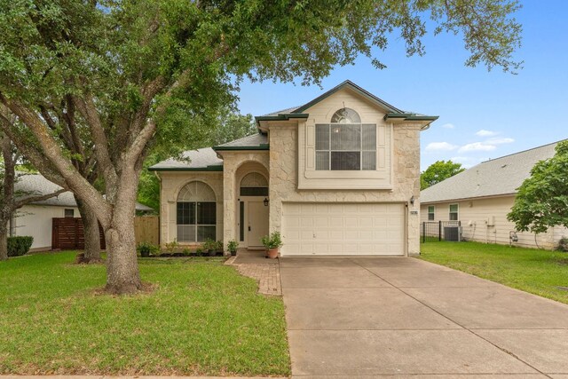 2917 Feathercrest Dr, Austin, TX 78728 - traditional-style house featuring stone siding, an attached garage, and driveway