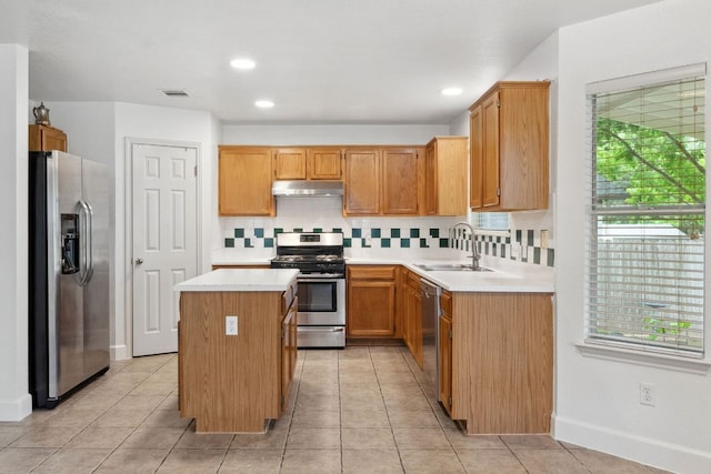2917 Feathercrest Dr, Austin, TX 78728 - kitchen with stainless steel appliances, under cabinet range hood, tasteful backsplash, light countertops, and a center island