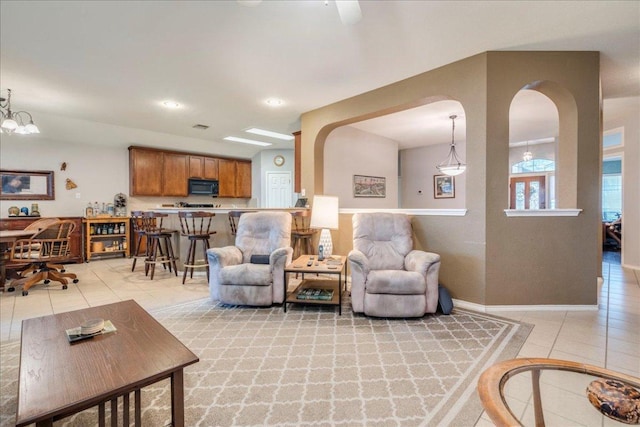 15115 Staked Plains Loop, Austin, TX 78717 - living area with light tile patterned flooring, arched walkways, baseboards, and recessed lighting