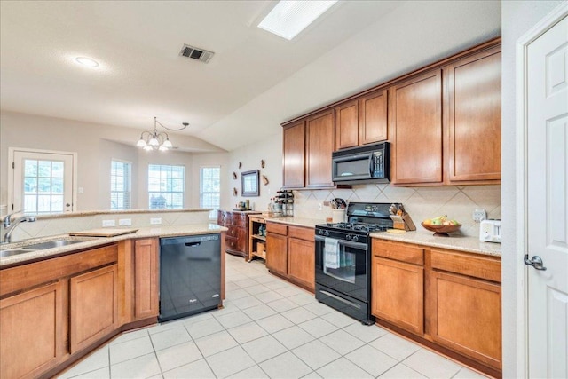 15115 Staked Plains Loop, Austin, TX 78717 - kitchen featuring black appliances, lofted ceiling, a sink, brown cabinets, and backsplash