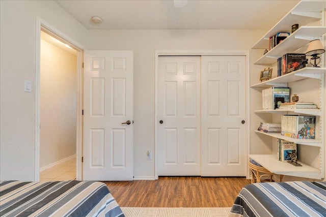 15115 Staked Plains Loop, Austin, TX 78717 - bedroom with wood finished floors, a closet, and baseboards