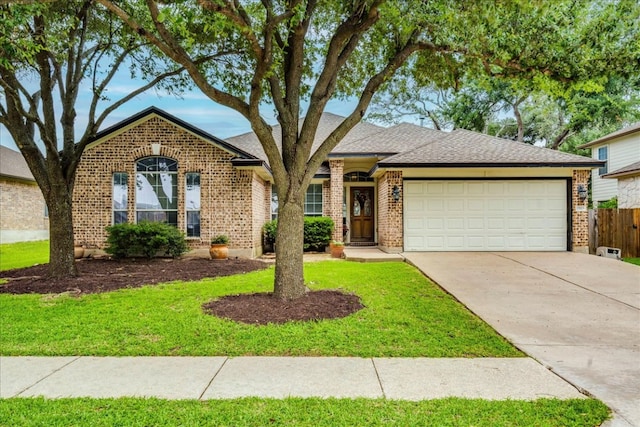 15115 Staked Plains Loop, Austin, TX 78717 - view of front of property with an attached garage, driveway, brick siding, and roof with shingles