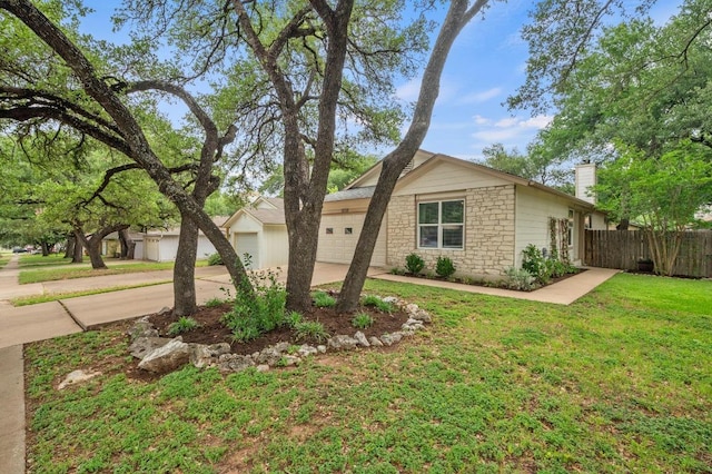 12721 Heinemann Dr, Austin, TX 78727 - view of front of home featuring a garage, concrete driveway, stone siding, and a chimney