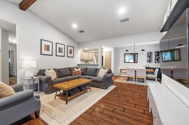 12721 Heinemann Dr, Austin, TX 78727 - living area featuring dark wood-style floors, recessed lighting, beamed ceiling, and high vaulted ceiling