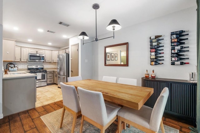 12721 Heinemann Dr, Austin, TX 78727 - dining area with light wood-style floors and recessed lighting