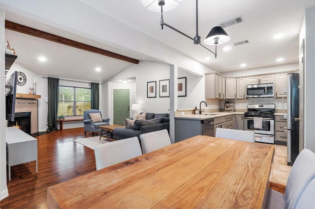 12721 Heinemann Dr, Austin, TX 78727 - dining room featuring wood finished floors, a lit fireplace, and recessed lighting