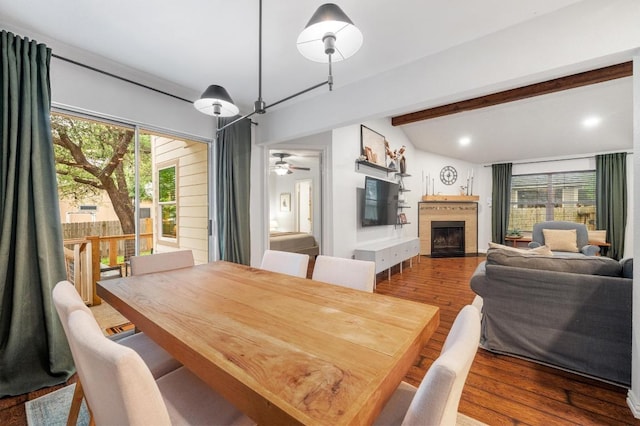 12721 Heinemann Dr, Austin, TX 78727 - dining area featuring a fireplace, a ceiling fan, wood finished floors, and lofted ceiling