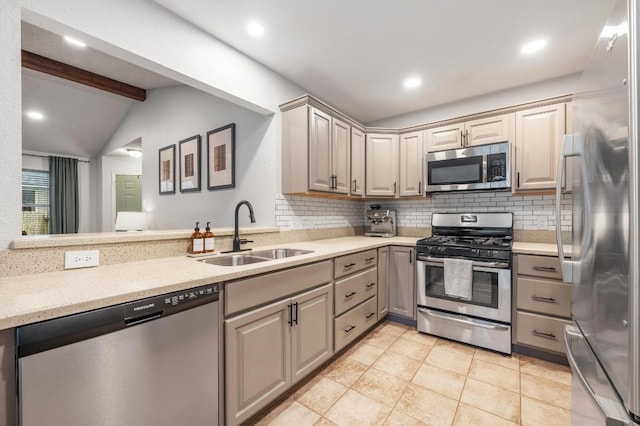 12721 Heinemann Dr, Austin, TX 78727 - kitchen featuring appliances with stainless steel finishes, a sink, tasteful backsplash, gray cabinetry, and light tile patterned floors