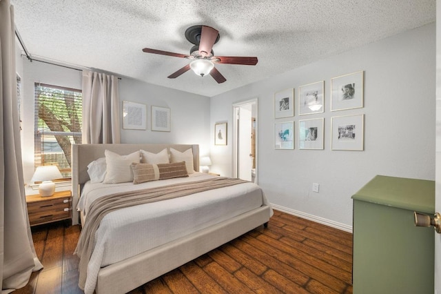 12721 Heinemann Dr, Austin, TX 78727 - bedroom with a textured ceiling, baseboards, wood finished floors, ceiling fan, and connected bathroom