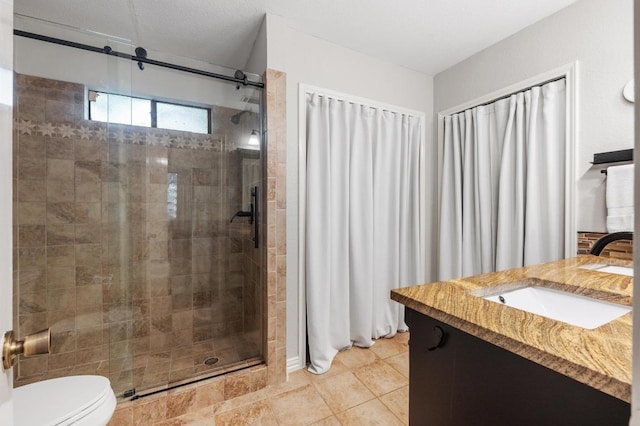 12721 Heinemann Dr, Austin, TX 78727 - bathroom featuring a stall shower, toilet, vanity, and tile patterned flooring