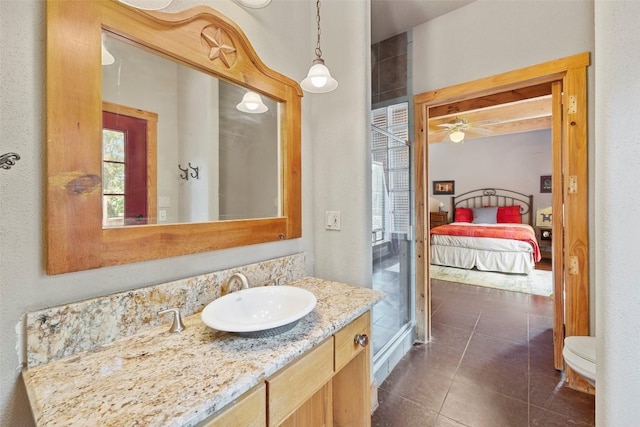 309 Cactus Trl, Johnson City, TX 78070 - ensuite bathroom with tile patterned floors, vanity, and ceiling fan