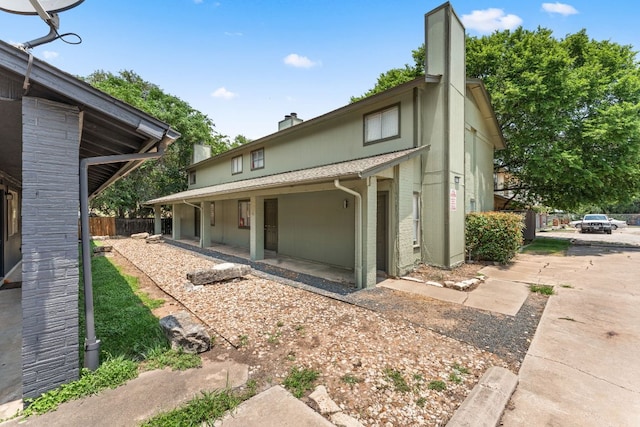 1320 Southport Dr, Austin, TX 78704 - rear view of house with a chimney