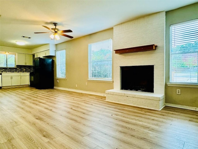 1320 Southport Dr, Austin, TX 78704 - unfurnished living room featuring ceiling fan, light wood-style flooring, healthy amount of natural light, and baseboards