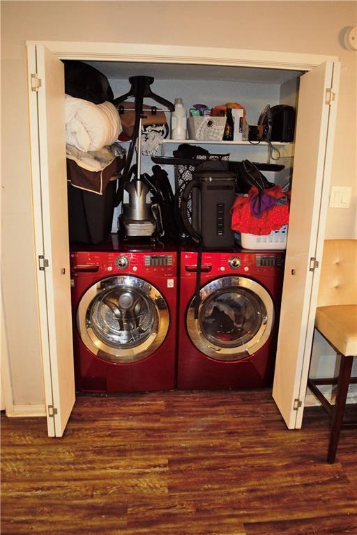 1320 Southport Dr, Austin, TX 78704 - washroom featuring washing machine and dryer and wood finished floors