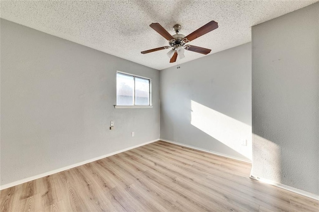 1320 Southport Dr, Austin, TX 78704 - spare room with wood finished floors, a ceiling fan, baseboards, and a textured ceiling