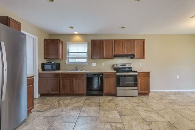 8912 Norwich Castle, Austin, TX 78747 - kitchen with black appliances, under cabinet range hood, light countertops, brown cabinets, and recessed lighting