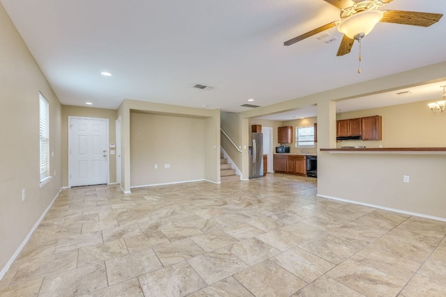 8912 Norwich Castle, Austin, TX 78747 - unfurnished living room with baseboards, light stone finish flooring, stairs, a ceiling fan, and recessed lighting