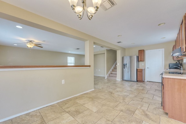 8912 Norwich Castle, Austin, TX 78747 - kitchen with stainless steel refrigerator with ice dispenser, brown cabinetry, light countertops, under cabinet range hood, and a chandelier