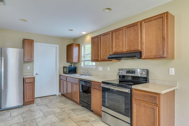 8912 Norwich Castle, Austin, TX 78747 - kitchen with appliances with stainless steel finishes, under cabinet range hood, light countertops, brown cabinetry, and recessed lighting