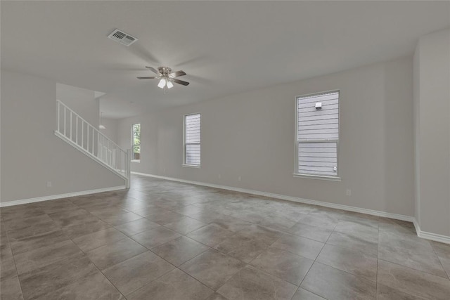 2038 Wind Chime Way, New Braunfels, TX 78130 - unfurnished room with stairway, a ceiling fan, tile patterned floors, and baseboards