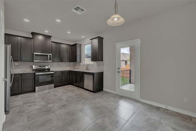 2038 Wind Chime Way, New Braunfels, TX 78130 - kitchen featuring stainless steel appliances, a sink, tasteful backsplash, light stone counters, and recessed lighting