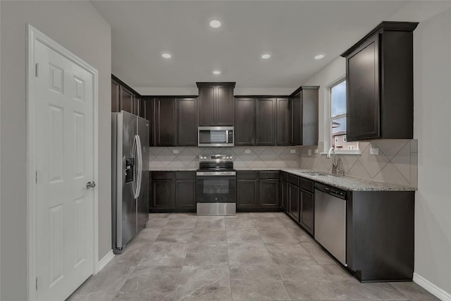 2038 Wind Chime Way, New Braunfels, TX 78130 - kitchen featuring stainless steel appliances, a sink, dark brown cabinetry, light stone counters, and tasteful backsplash