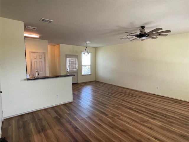 408 Azurite Dr, Jarrell, TX 76537 - unfurnished living room with dark wood finished floors, a ceiling fan, and a sink