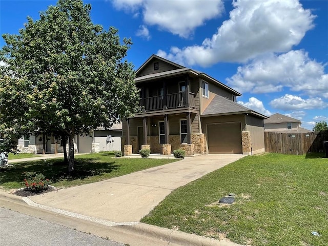 408 Azurite Dr, Jarrell, TX 76537 - traditional home with stone siding, driveway, a balcony, an attached garage, and a porch