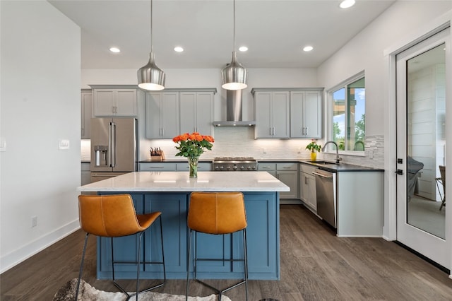 1215 Lake Shore Dr, Spicewood, TX 78669 - kitchen featuring stainless steel appliances, wall chimney exhaust hood, a sink, dark wood-style floors, and tasteful backsplash