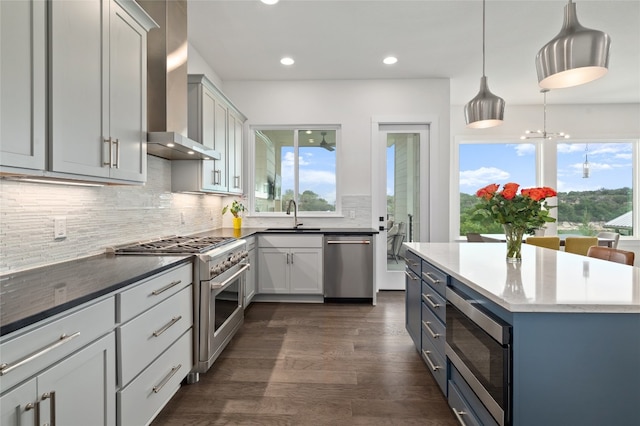 1215 Lake Shore Dr, Spicewood, TX 78669 - kitchen featuring appliances with stainless steel finishes, a sink, dark wood-style flooring, tasteful backsplash, and recessed lighting