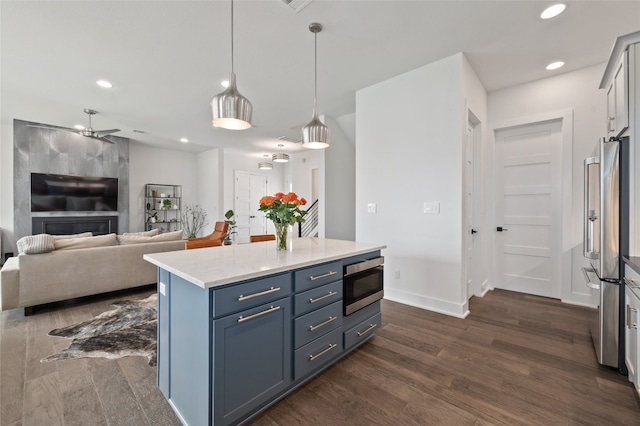 1215 Lake Shore Dr, Spicewood, TX 78669 - kitchen featuring dark wood-style flooring, stainless steel appliances, decorative light fixtures, open floor plan, and recessed lighting