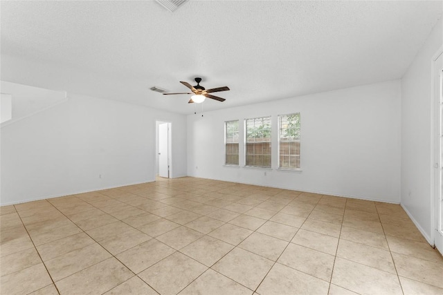 491 Emerald Fields Ln, Kyle, TX 78640 - unfurnished room featuring light tile patterned floors, a ceiling fan, and a textured ceiling