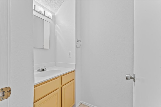 491 Emerald Fields Ln, Kyle, TX 78640 - bathroom featuring a textured ceiling and vanity