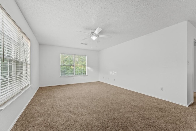 491 Emerald Fields Ln, Kyle, TX 78640 - carpeted spare room featuring a ceiling fan, a textured ceiling, and baseboards