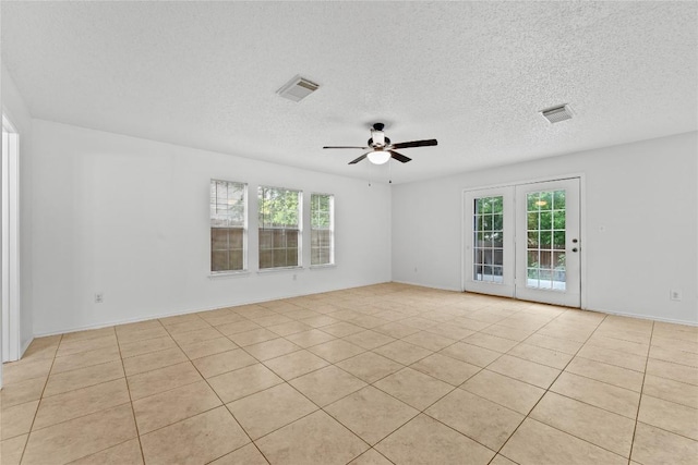 491 Emerald Fields Ln, Kyle, TX 78640 - unfurnished room with a ceiling fan, light tile patterned floors, and a textured ceiling