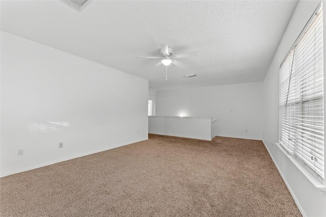 491 Emerald Fields Ln, Kyle, TX 78640 - carpeted empty room with ceiling fan, a textured ceiling, and baseboards